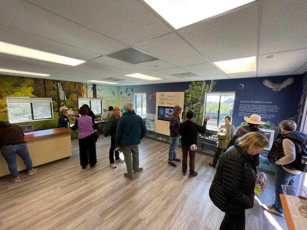 Several people explore a variety of interpretive nature exhibits inside the new center.
