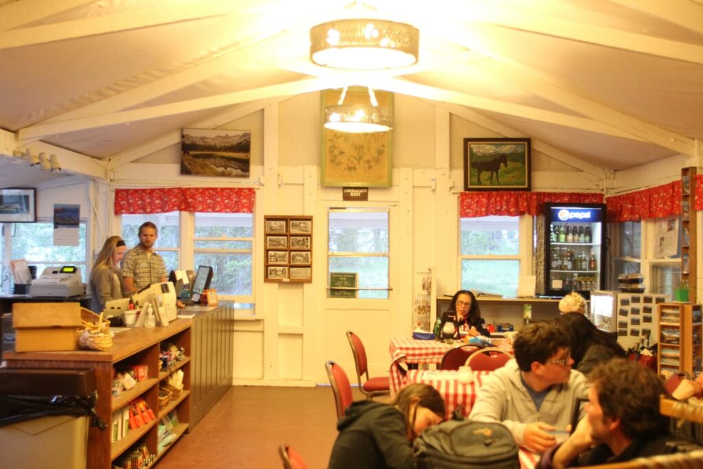 A brightly lit dining room with a cash register and goods for sale