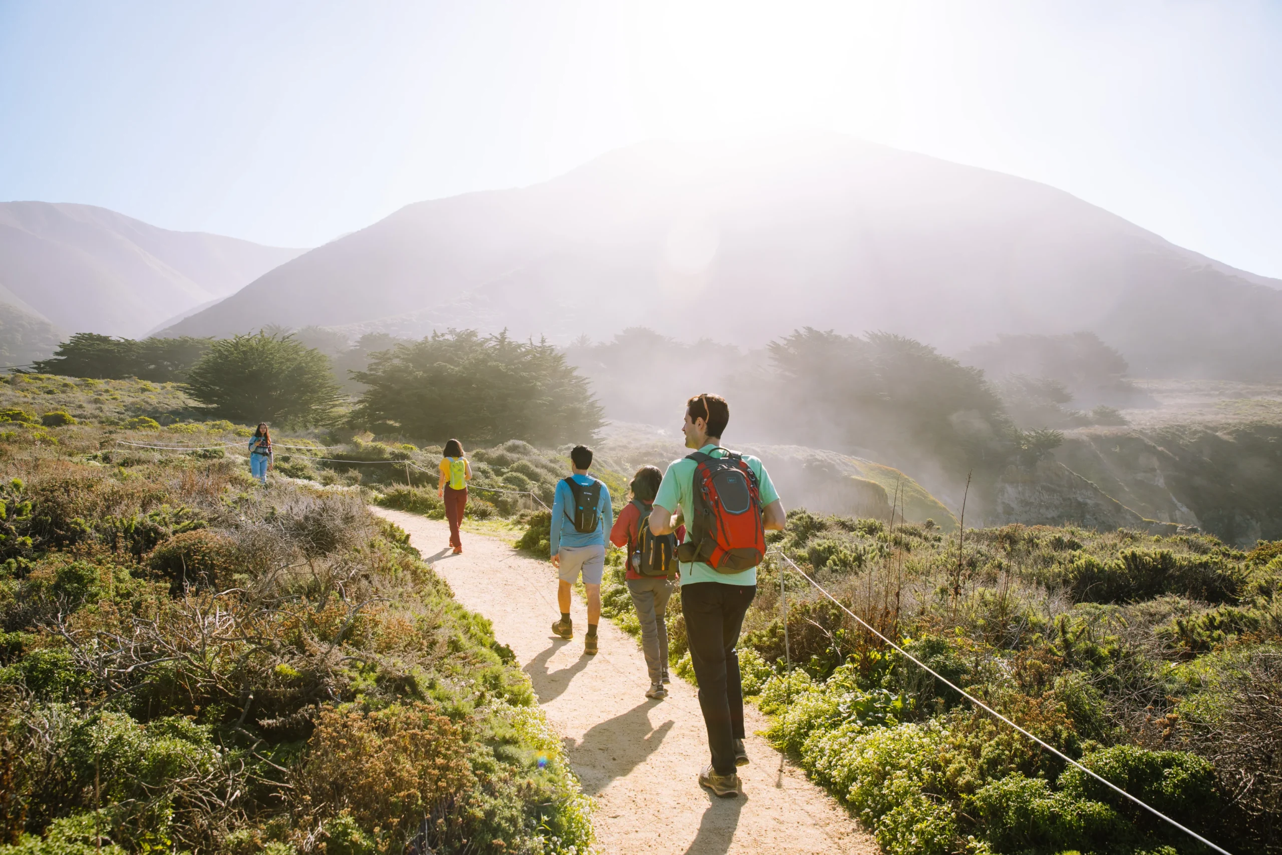 group of friends hikes at Garrapata Beach