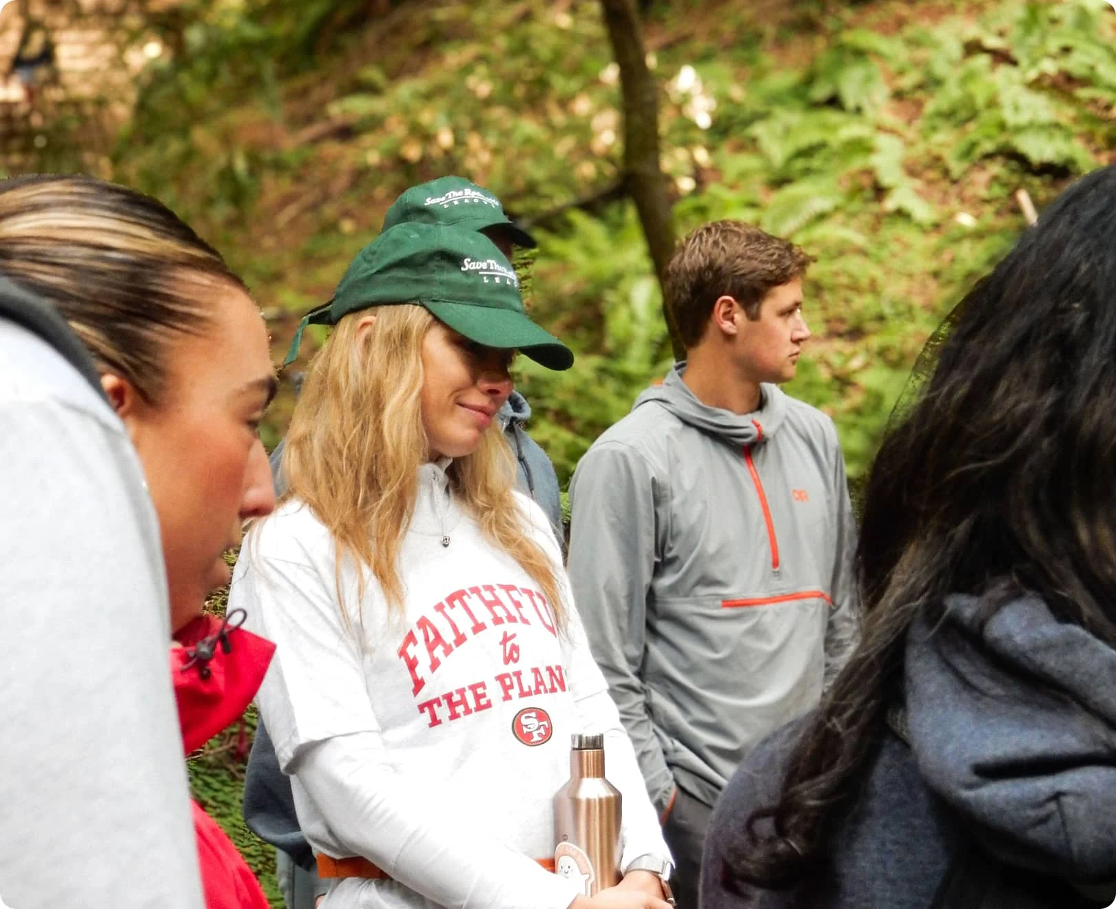 Volunteers wearing Save the Redwoods League hats on a guided forest tour in California