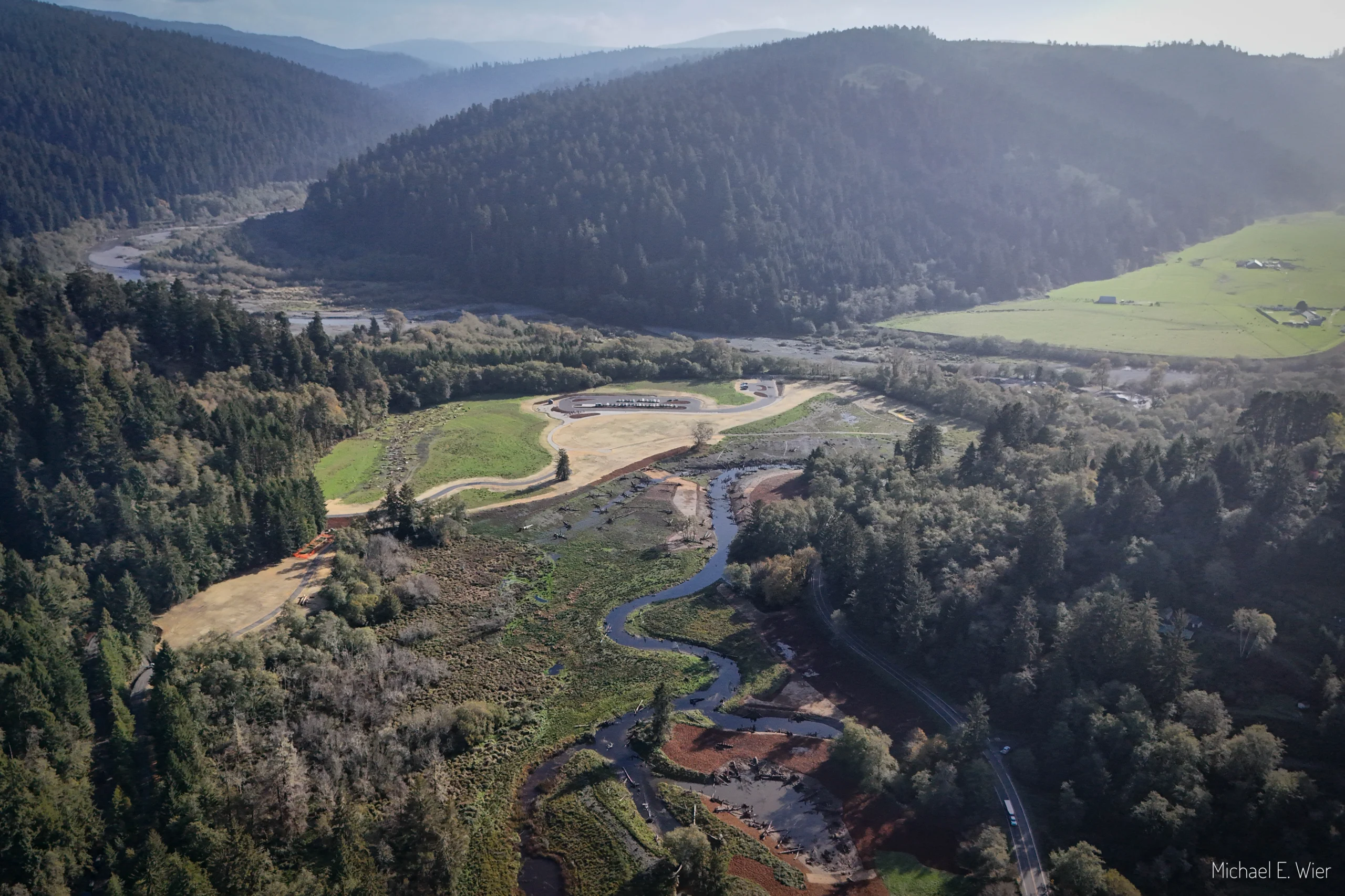 Aerial view of creek watershed and redwood forest.