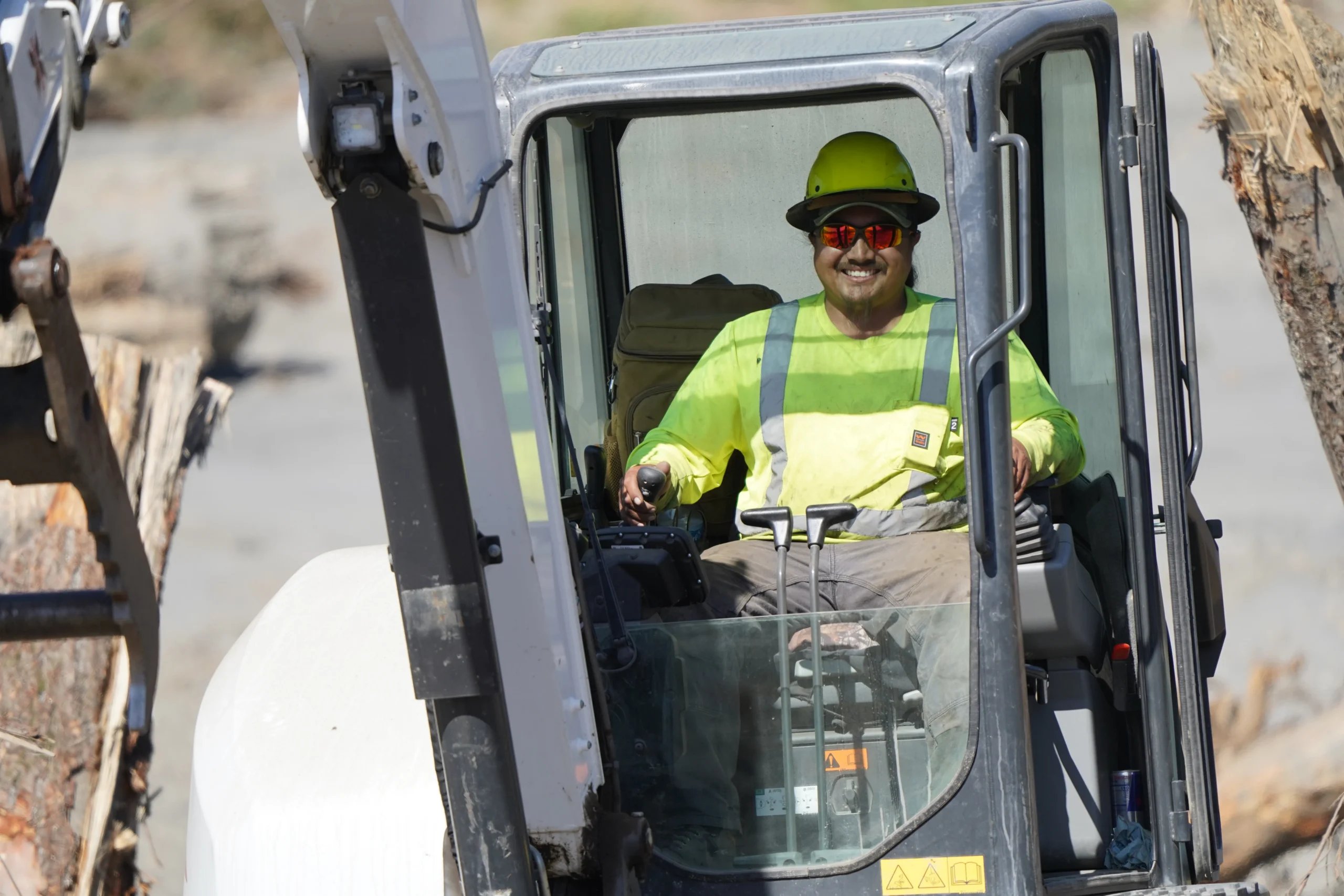 A construction crew member operating heavy machinery