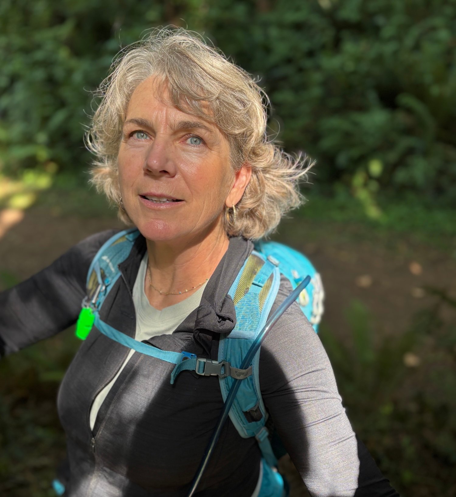 Person wearing a hiking backpack in the forest